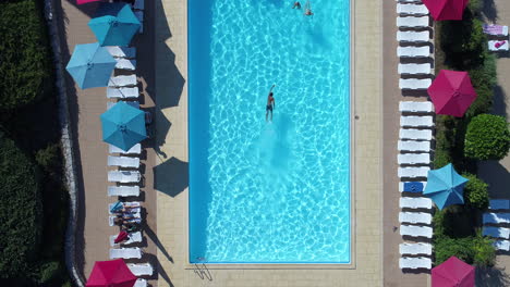 Man-in-a-swimming-pool-luxury-hotel-aerial-drone-view